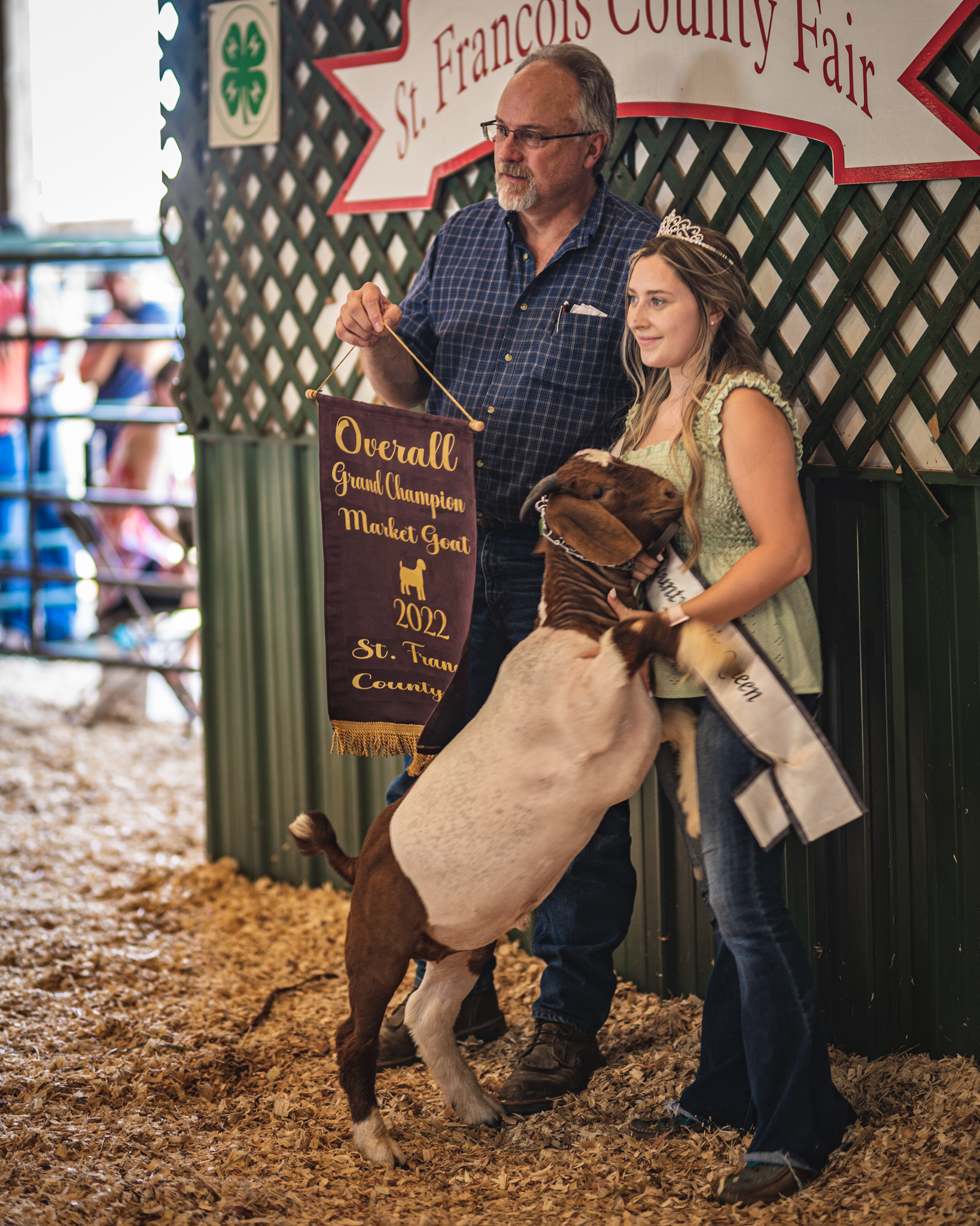Jayden Carrow with a goat and the Overall Grand Champion Market Goat reward